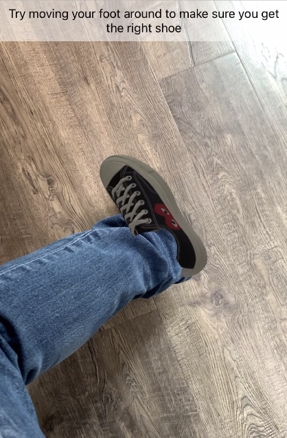 Virtual try-on experience showing AR shoe on user's foot